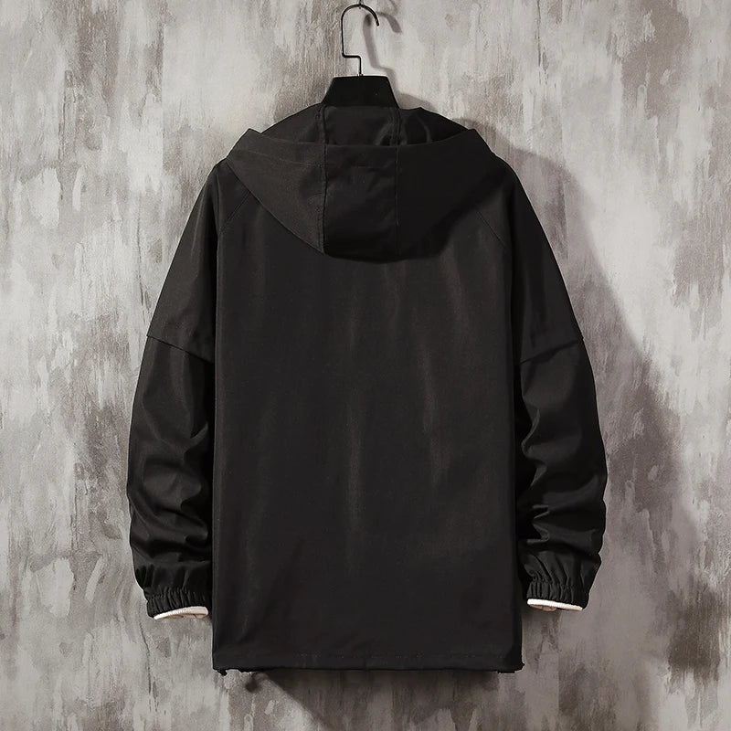 Anorak de lluvia Flash de THE LJM en color brillante con capucha y cierre frontal, ideal para protección contra la lluvia.