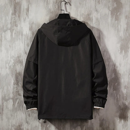 Anorak de lluvia Flash de THE LJM en color brillante con capucha y cierre frontal, ideal para protección contra la lluvia.